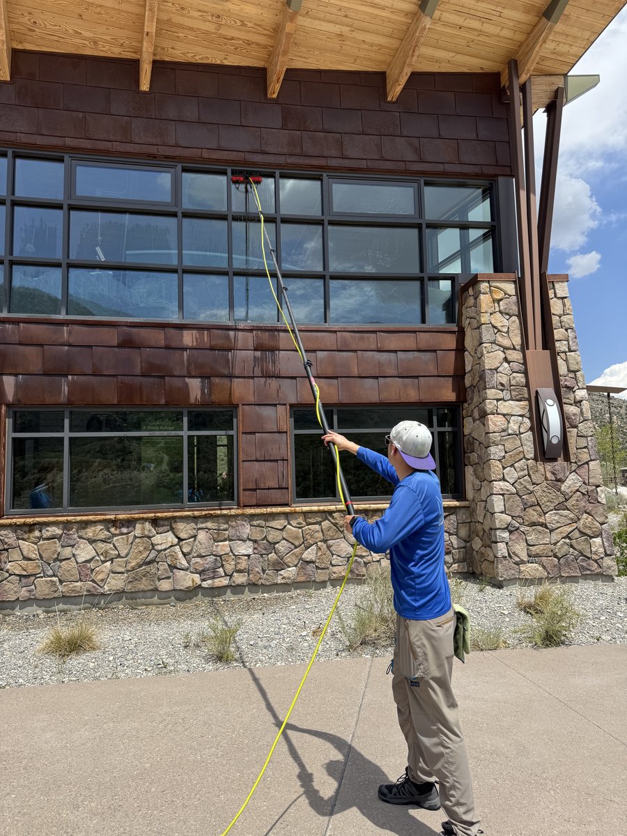 Neon Window Cleaning technician using water-fed pole at Spring Mountains Visitor Gateway