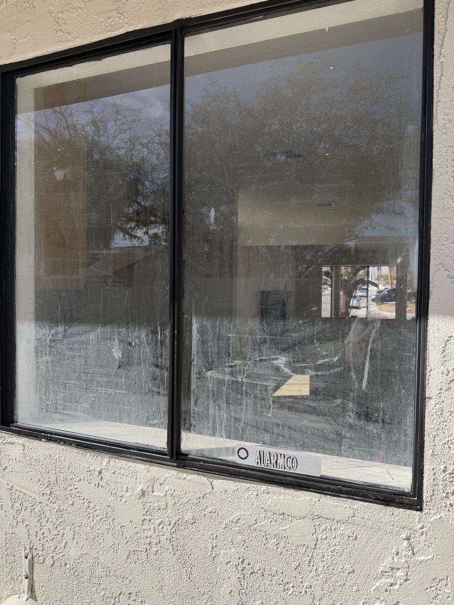 Las Vegas window showing buildup of desert dust and hard water mineral stains