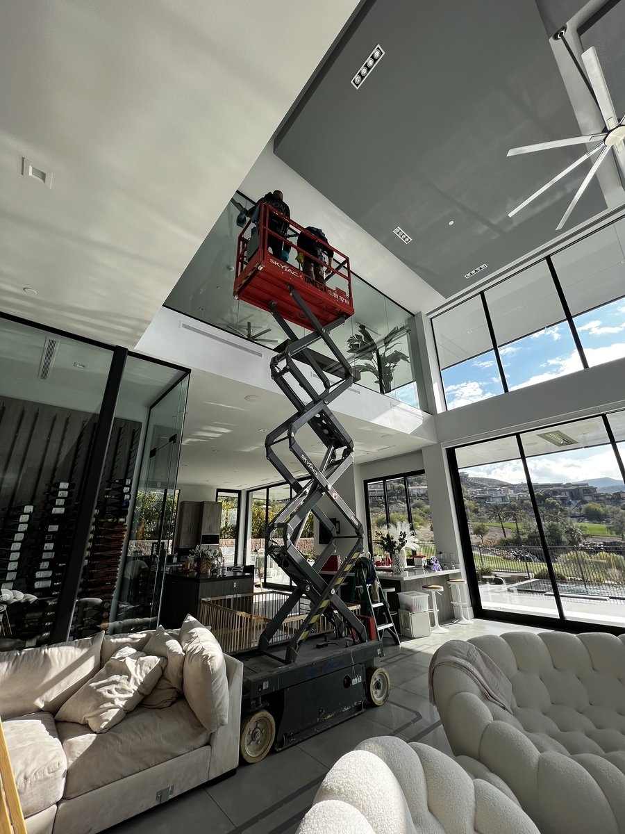 Interior skylight window cleaning using a scissor lift in a luxury Las Vegas home